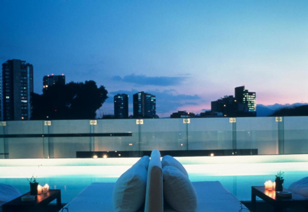 Rooftop pool in hotel habita at night 