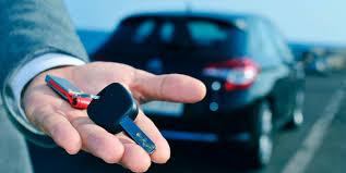 Man handing over key of a rental car 