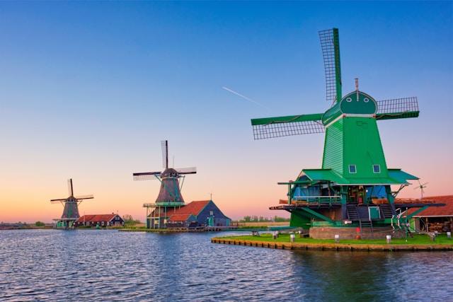 a group of windmills on a lake in the Netherlands